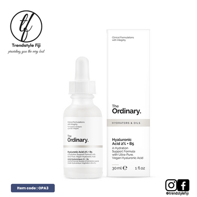 The image shows a product packaging for 'The Ordinary Hyaluronic Acid 2% + B5' which is presented as a serum in a white dropper bottle with a white label. The packaging includes the brand's logo and the product name, indicating it as a hydrator oil with hyaluronic acid and vitamin B5.